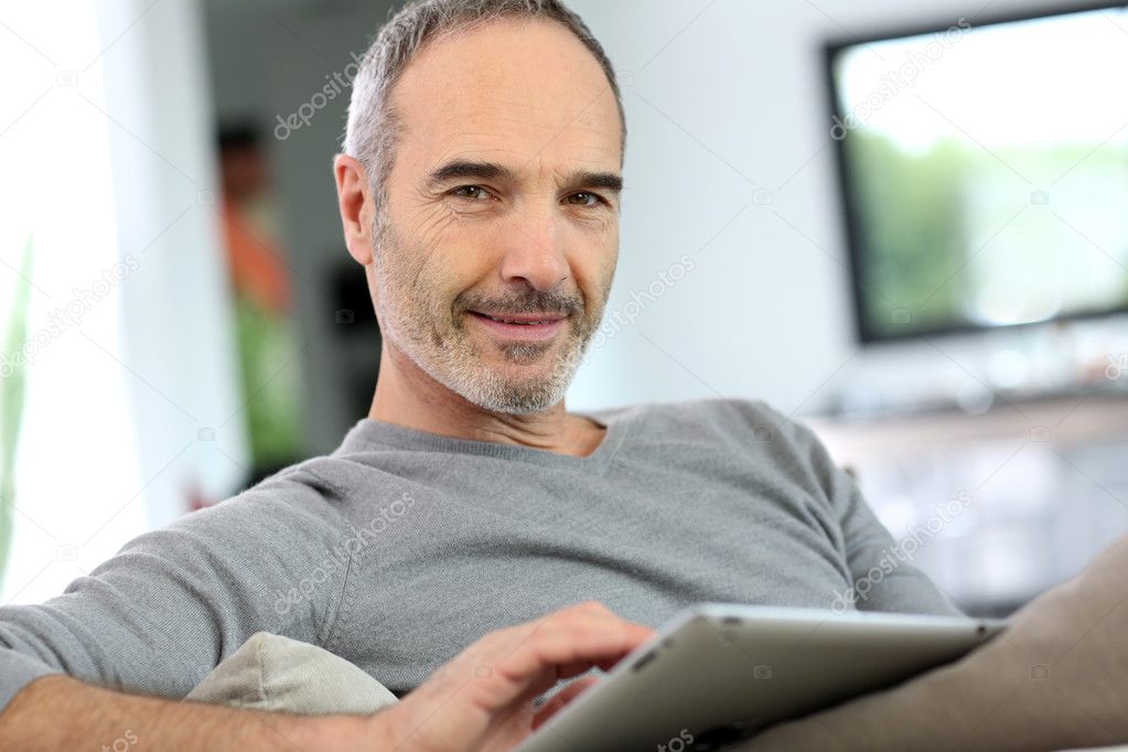 Man at home with tablet