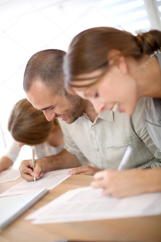 People filling admission form