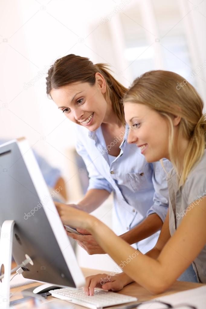 Smiling businesswomen working on computer