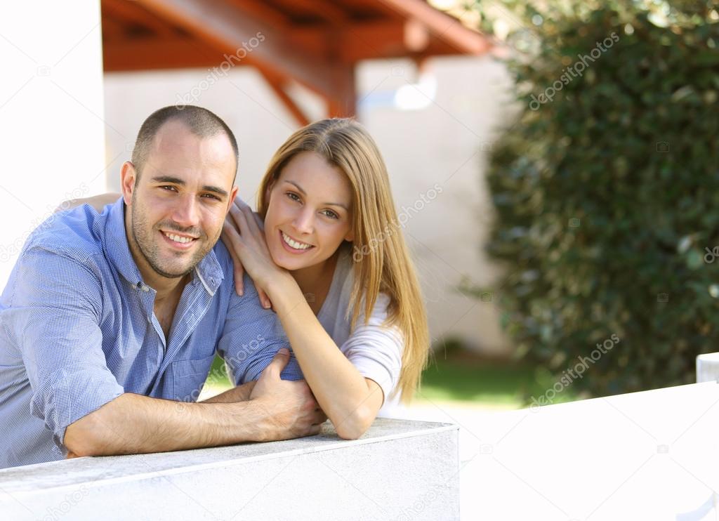 Couple in front of home