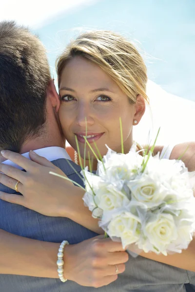 Bride embracing husband — Stock Photo, Image