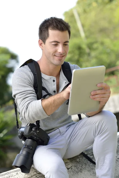 Reporter checking on work with tablet — Stock Photo, Image