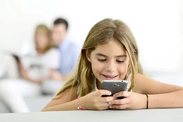 Girl playing with smartphone — Stock Photo, Image