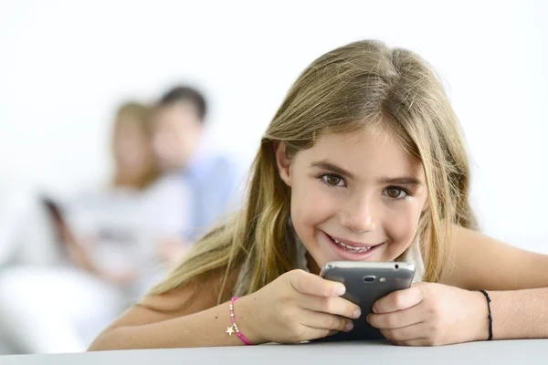 Girl playing with smartphone — Stock Photo, Image