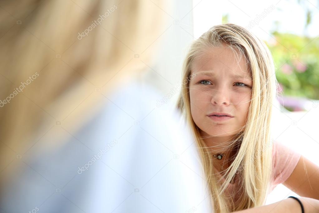Mother talking to teenaged girl