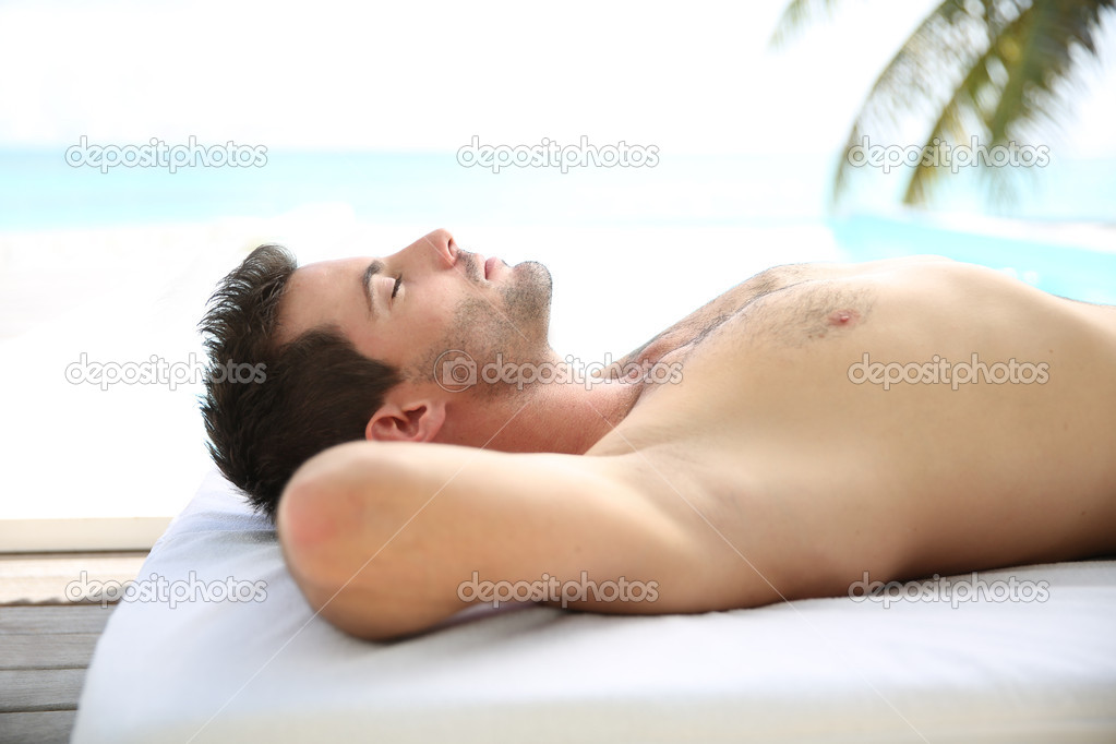 Man relaxing on massage bed