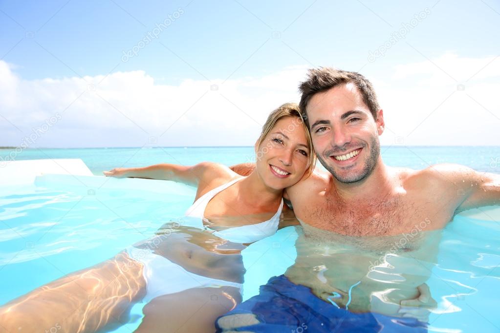 Couple swimming in infinity pool