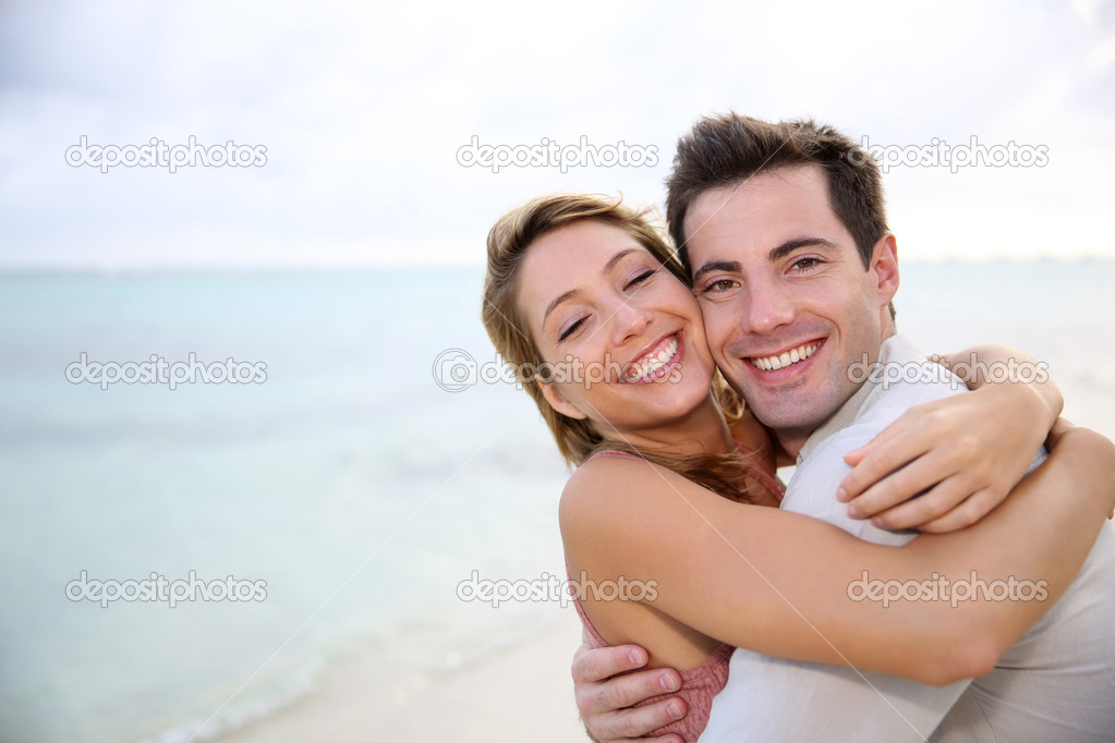 Couple embracing by the beach