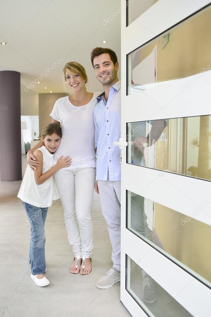 Family standing at front door