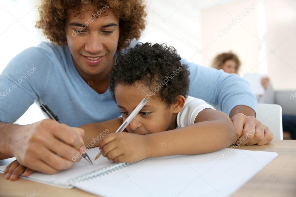Daddy and son drawing in notebook