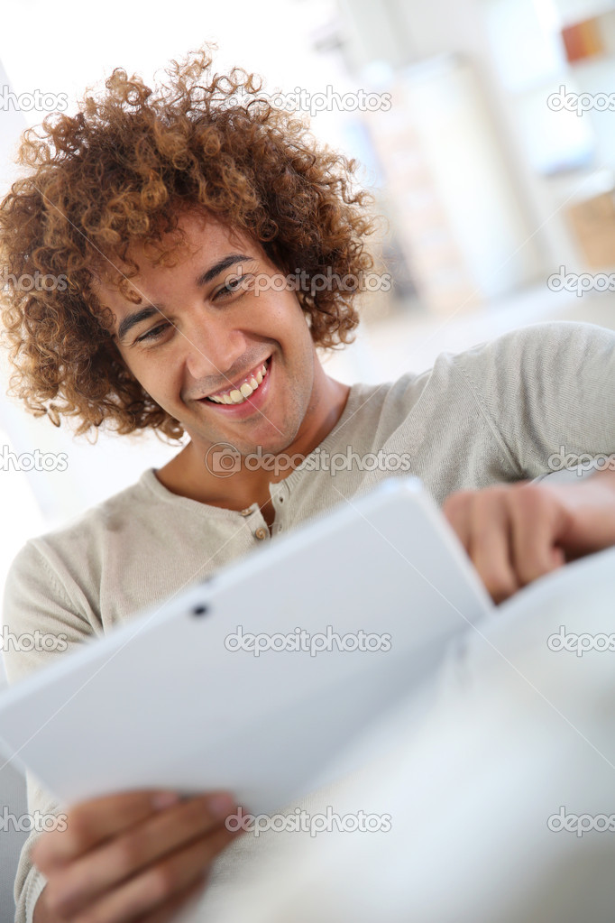 Guy websurfing on tablet