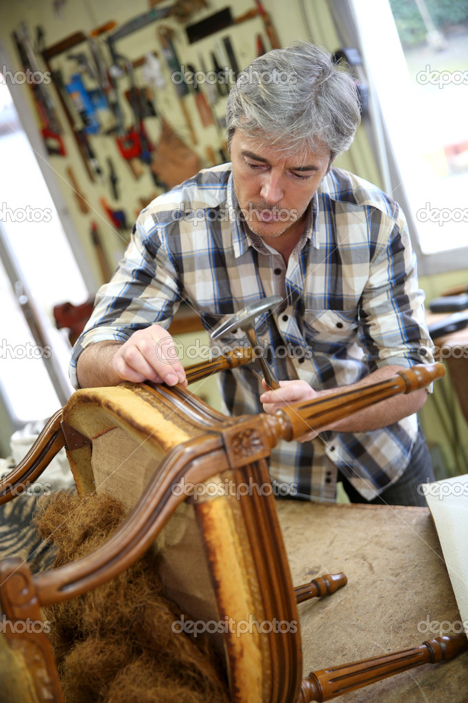 Craftsman repairing armchair