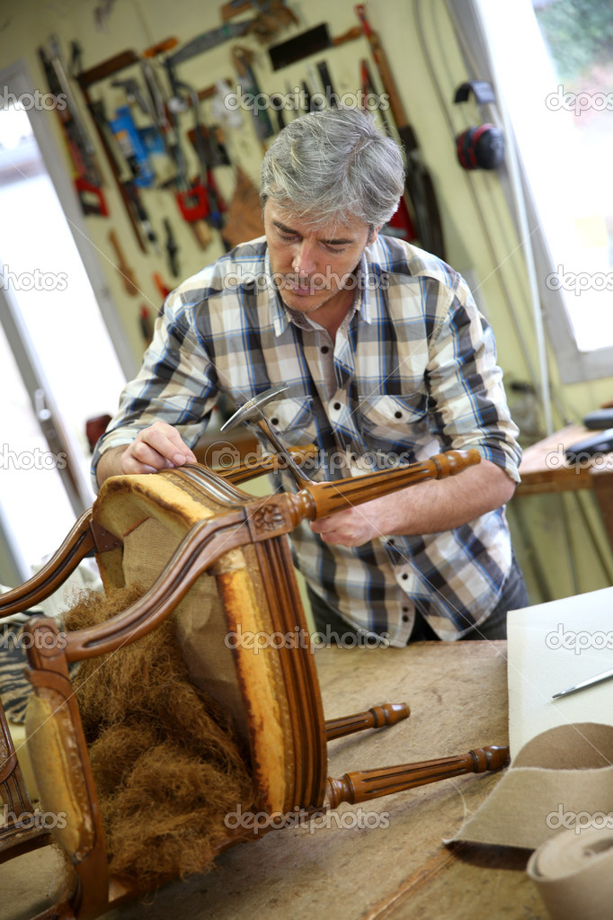 Craftsman repairing armchair