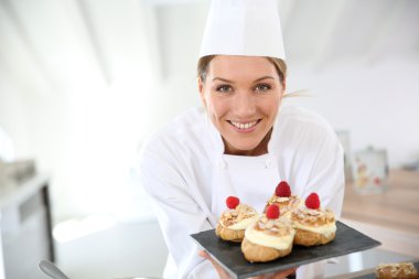 Pastry chef showing desserts clipart
