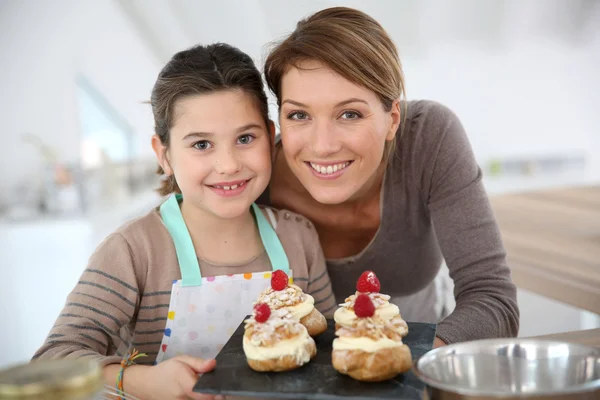 Mother and daughter preparing puffs