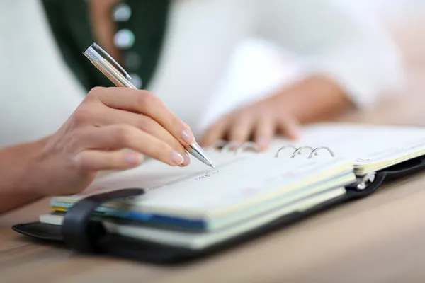 Hand writing on agenda — Stock Photo, Image