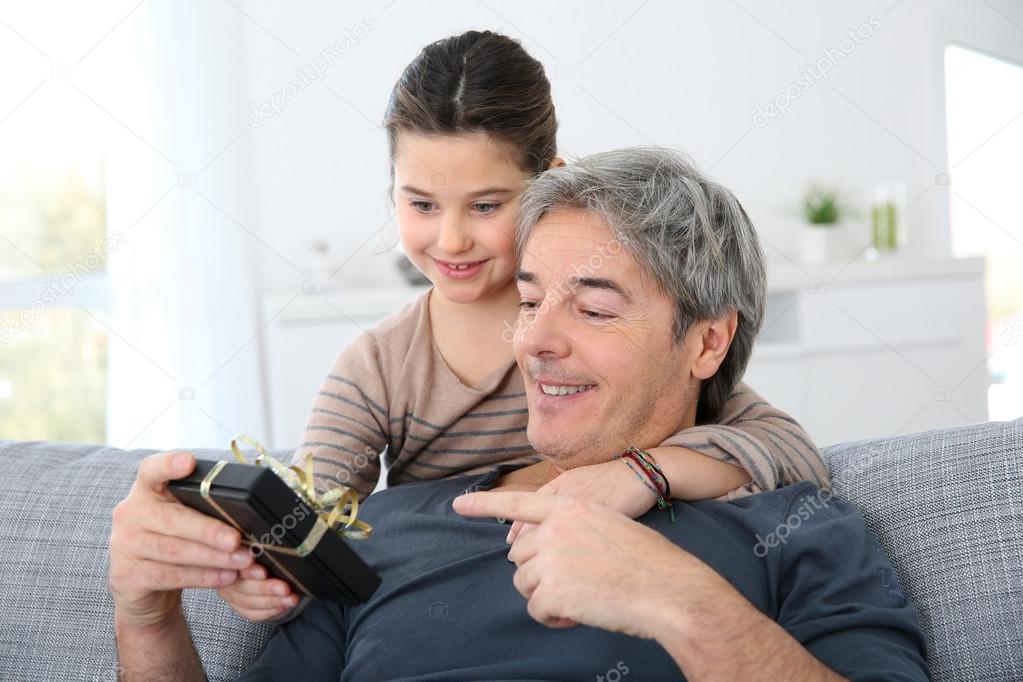 Girl giving present to daddy