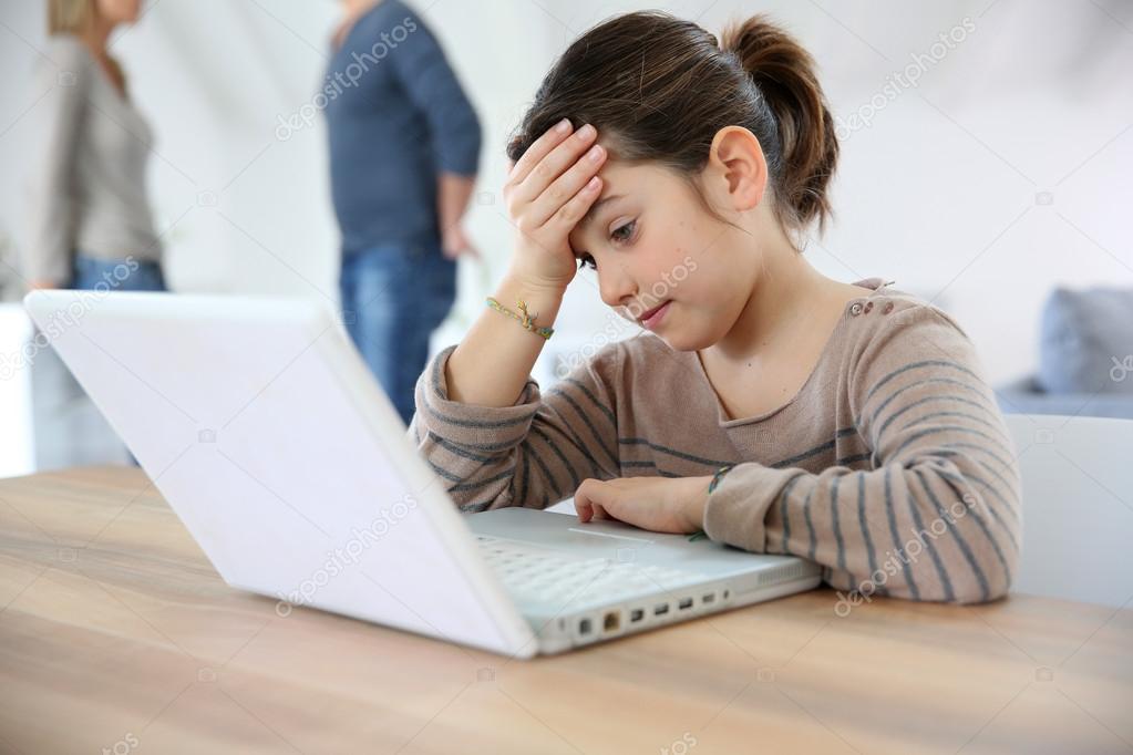 Girl doing homework on laptop