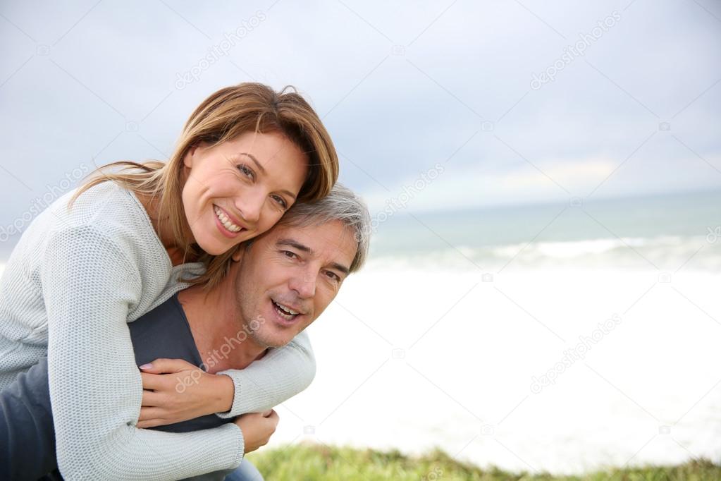 Man carrying woman on his back