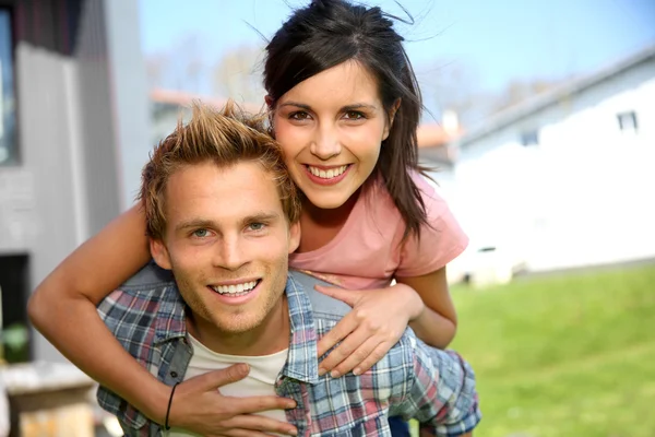 Man giving piggyback ride to girlfriend — Stock Photo, Image