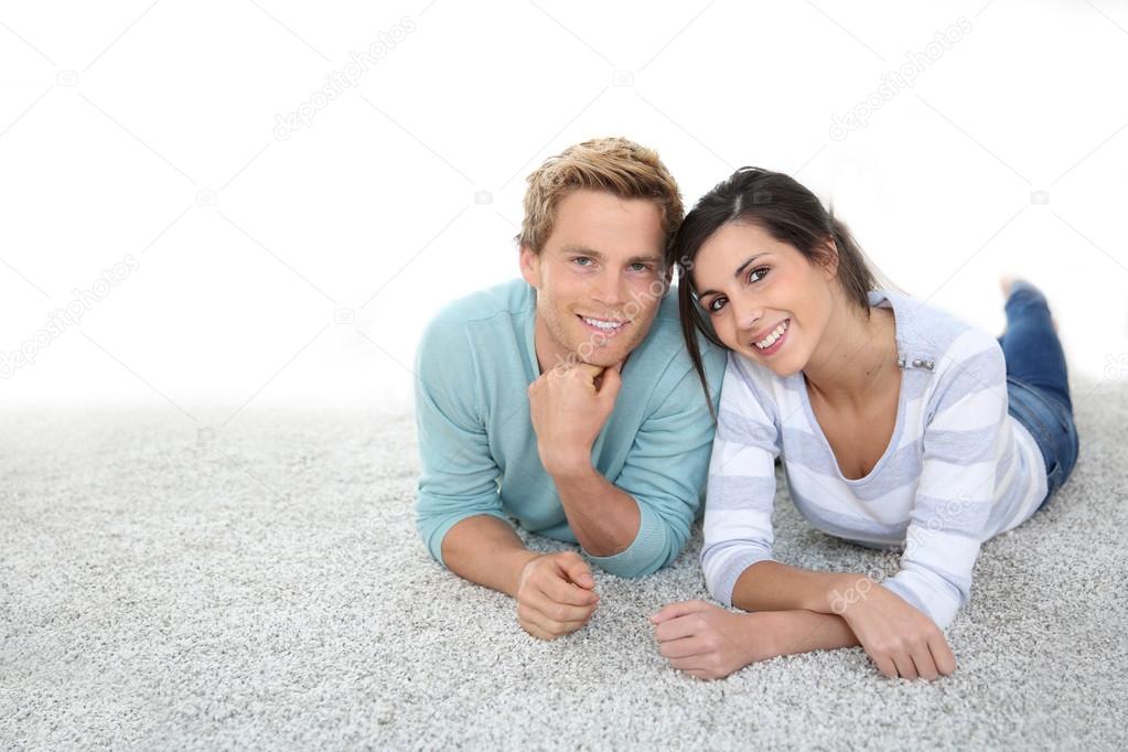 Couple laying on carpet floor
