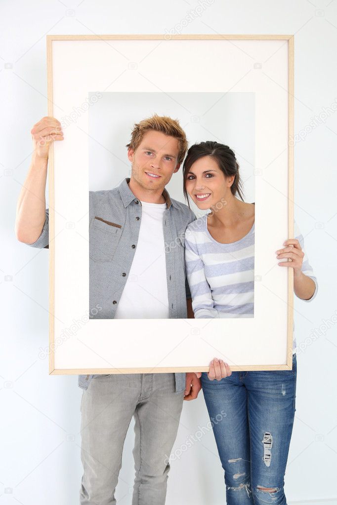 Couple holding picture frame