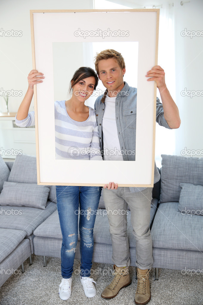 Couple holding picture frame
