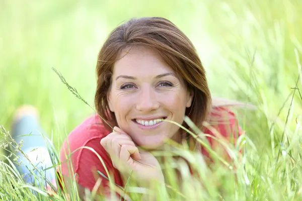 Woman with sprout in field — Stock Photo, Image