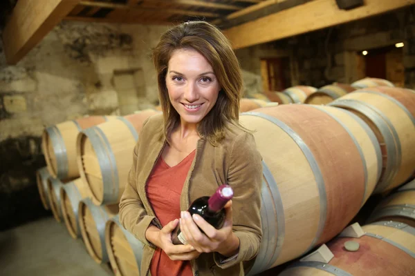 Woman holding bottle of wine — Stock Photo, Image