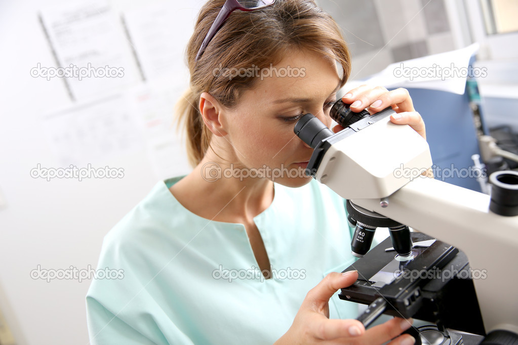 Doctor in laboratory with microscope