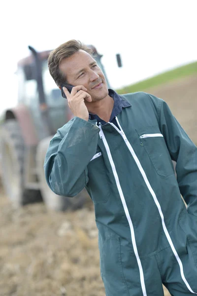 Farmer talking on mobile phone — Stock Photo, Image