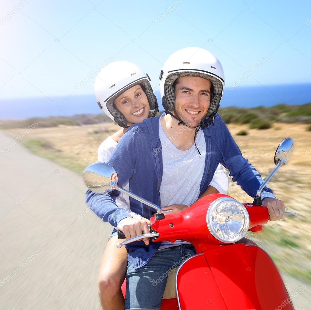 Mature Man Riding Motorcycle Carrying Bouquet Of Flowers