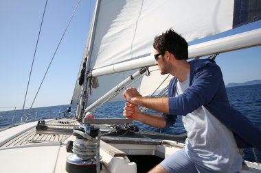 Man sailing with sails out clipart