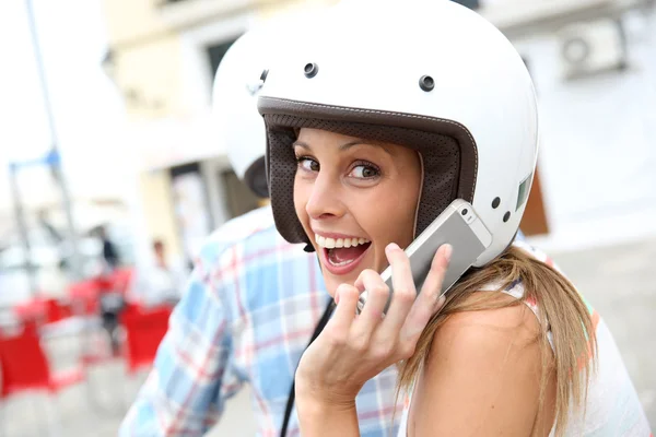 Girl on moto using smartphone — Stock Photo, Image