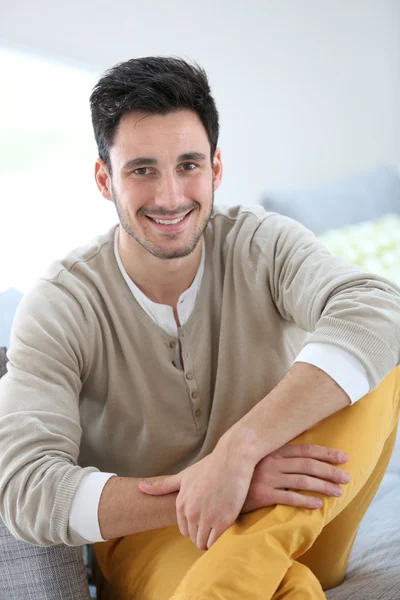 Man relaxing on sofa — Stock Photo, Image