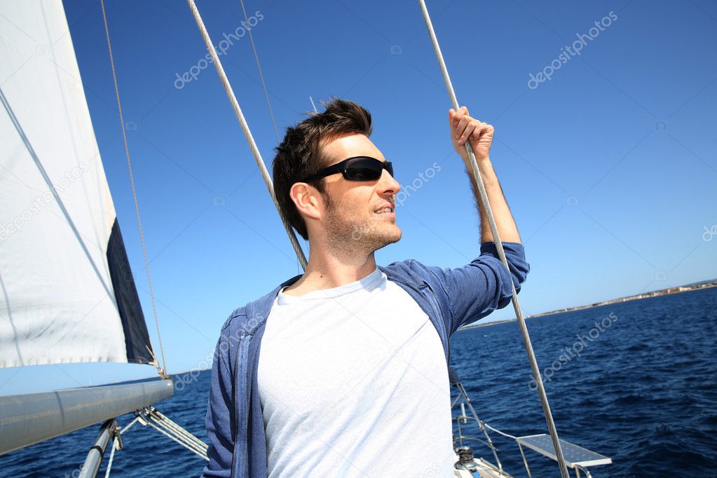 Skipper standing on sailboat