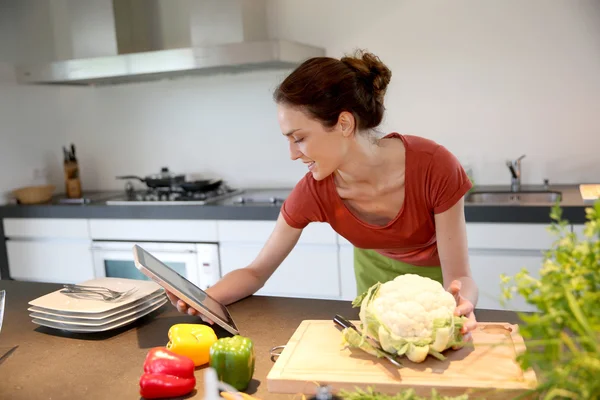 Woman looking at recipe on tablet — Stock Photo, Image