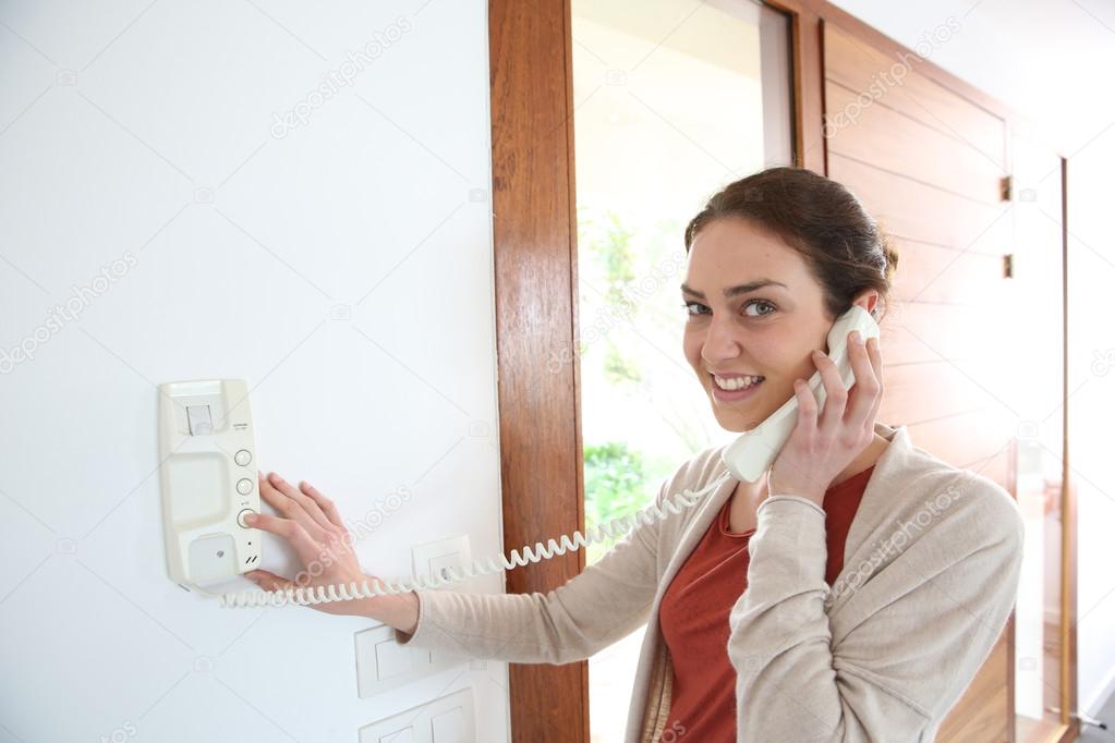 Woman answering security phone