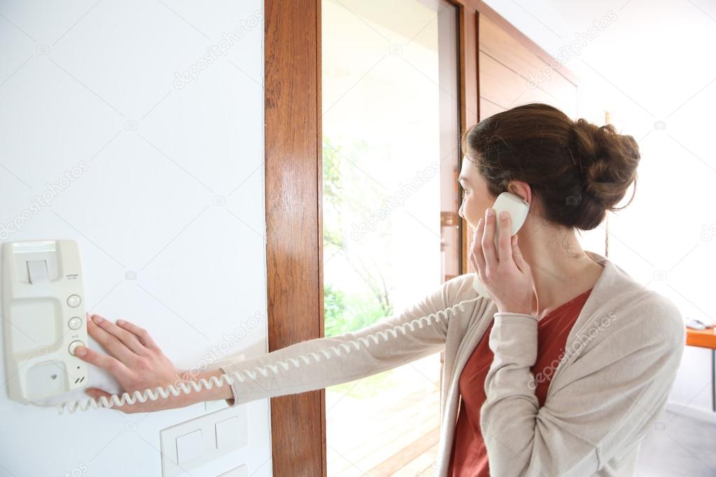 Woman answering security phone