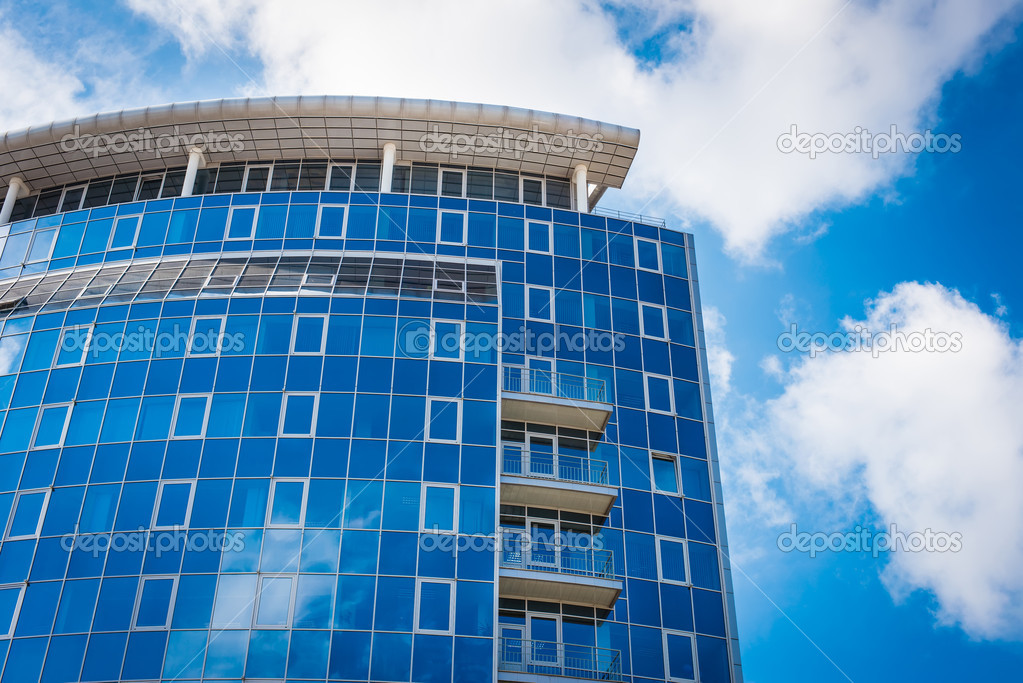 Office Building - blue sky and clouds reflections in windows