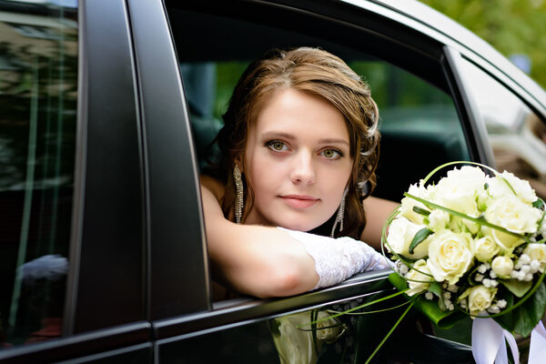 portrait bride in a car window