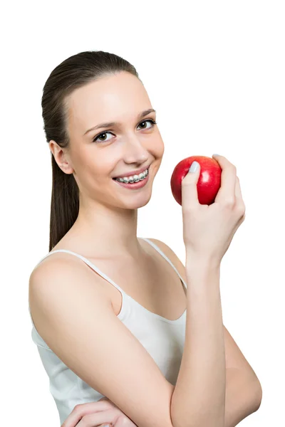 Young woman with apple and brackets on teeth — Stock Photo, Image