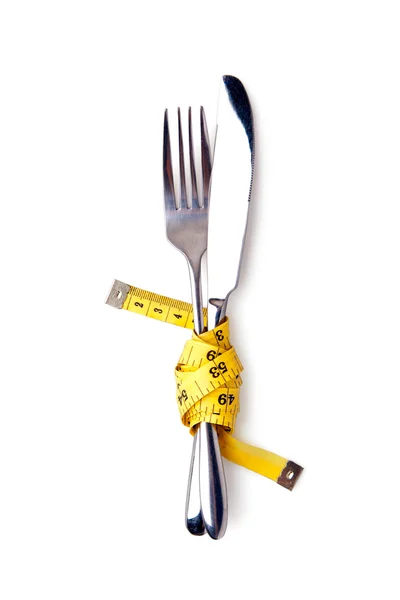 Svinovací metr na vidličku a nůž, koncept — Stock fotografie