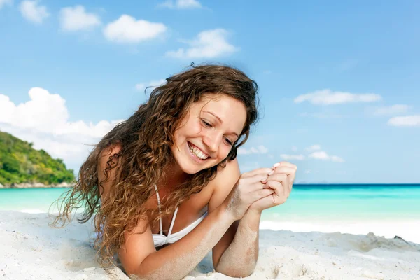 Portrait of a happy young woman posing while on the beach Stock Picture