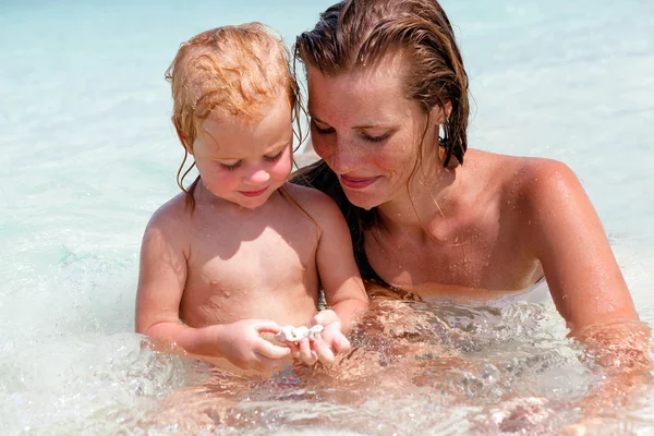 Mother with little daughter on the beach Stock Photo