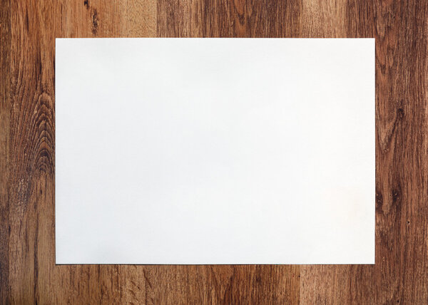 This is a photo of the blank paper on wooden background.