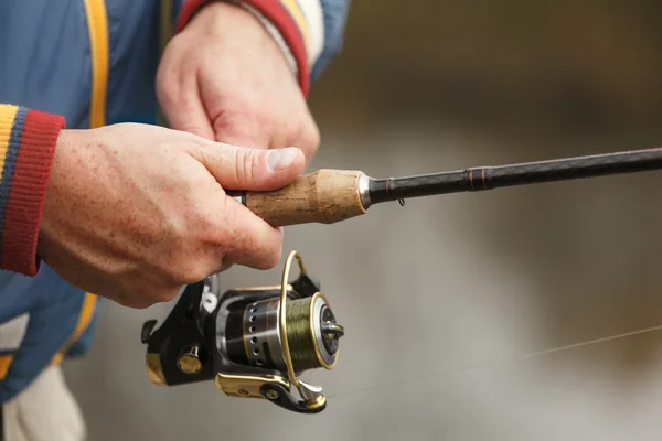 Fisherman hands with spinning. — Stock Photo, Image