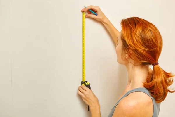 Portrait of young woman with measuring tape. — Stock Photo, Image