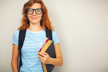 Kitaplar ile genç zeki öğrenci portresi.