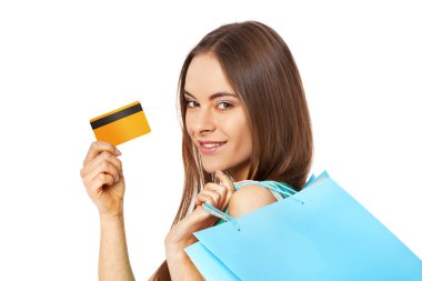 Happy beautiful woman with shopping bags and gold credit card isolated on white background.